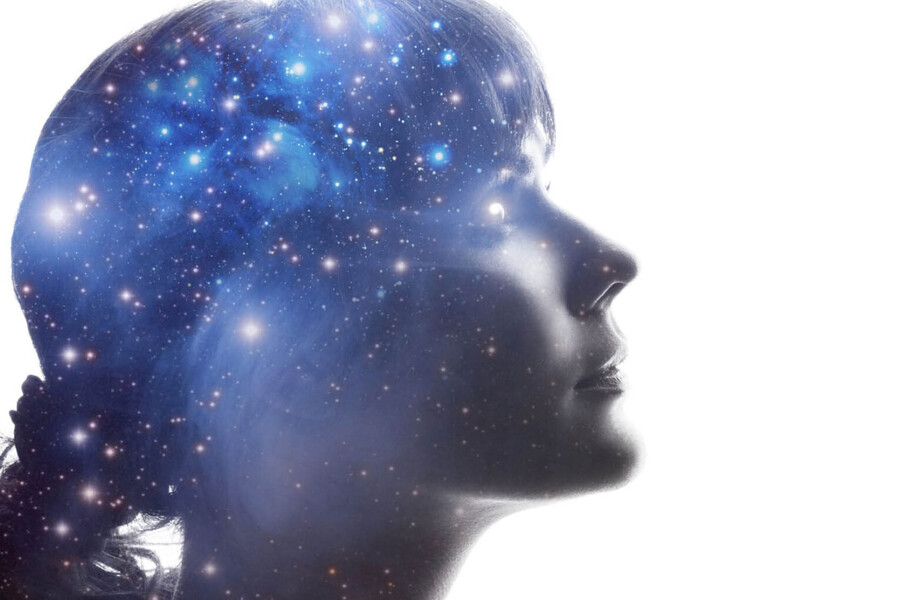 A profile image of a young woman's face, with a network of blue stars superimposed over her cranium