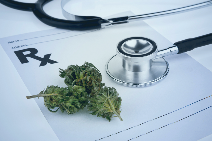 Cannabis sitting alongside a prescription pad and a stethoscope