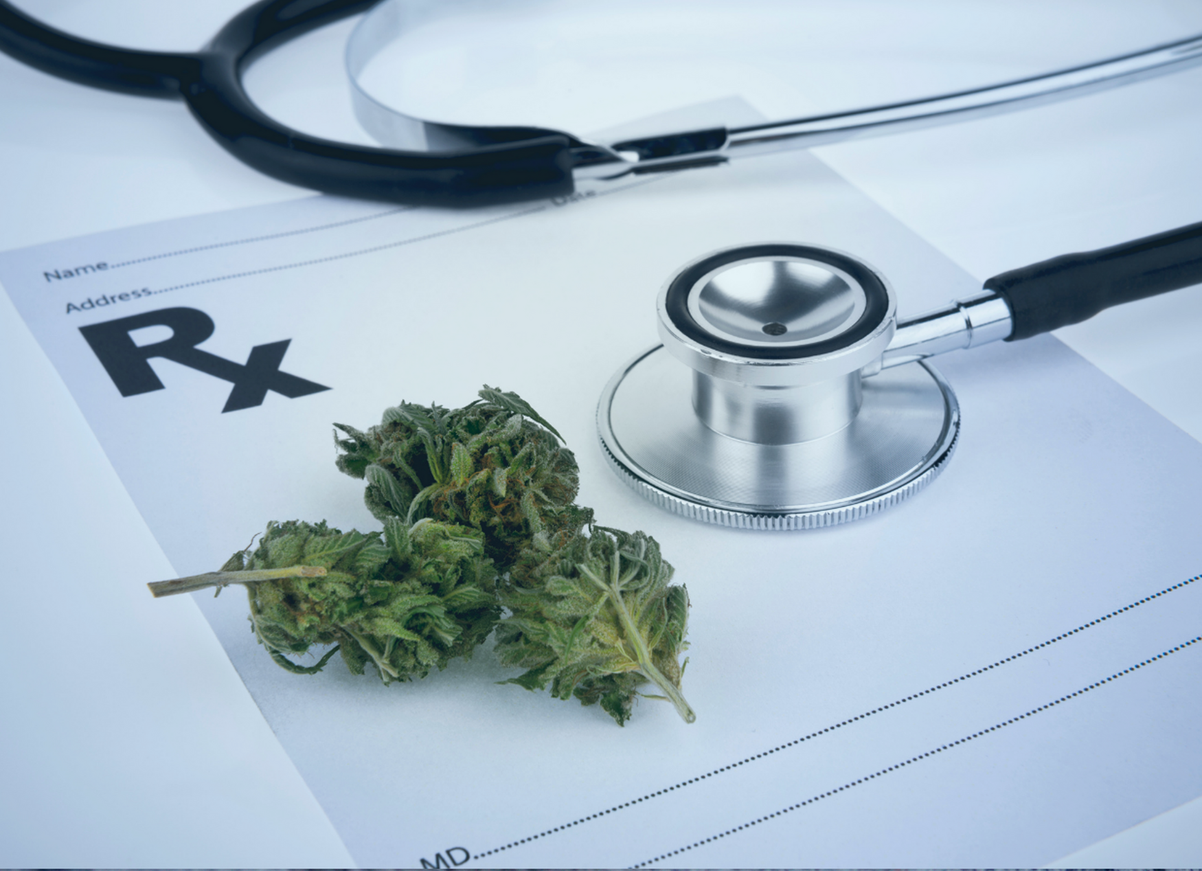 Cannabis sitting alongside a prescription pad and a stethoscope