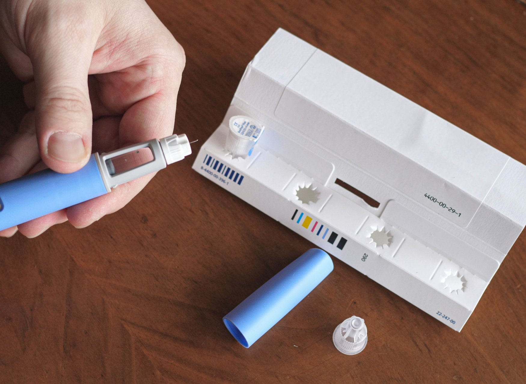 A person preparing a Semaglutide injection pen.