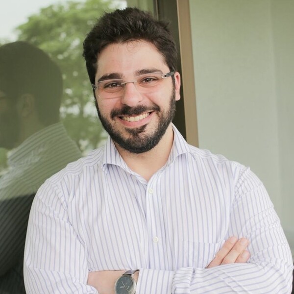 A smiling man with a beard and glasses.